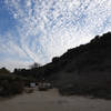 Start of the Fishhead trail under streaky and puffy sky.