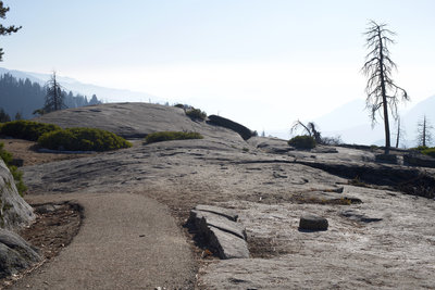 The narrow paved trail and Beetle Rock.  Even on a clear day in the Giant Forest, you can see the smog obscuring the view of the San Joaquin Valley.