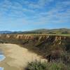 Pacific Ocean, beach, sandstone cliffs, green fields and hills = the West Coast. Seen looking north from the Seal Rock Overlook Spur.