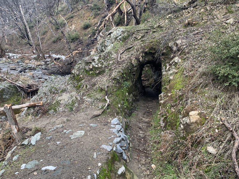 Water ditch tunnel through rock.