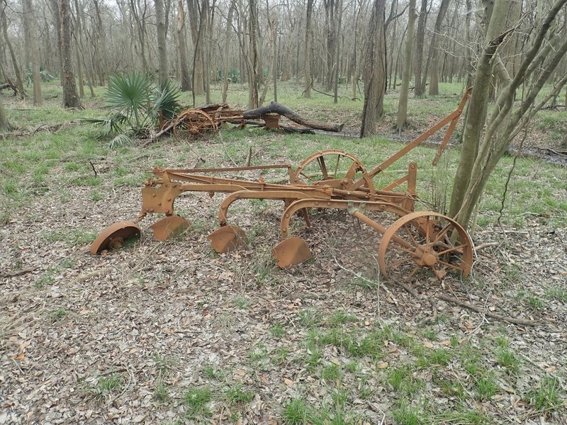 Intersection of Miles and Hermann Trails, southeast corner. One of three places with abandoned farm equipment.