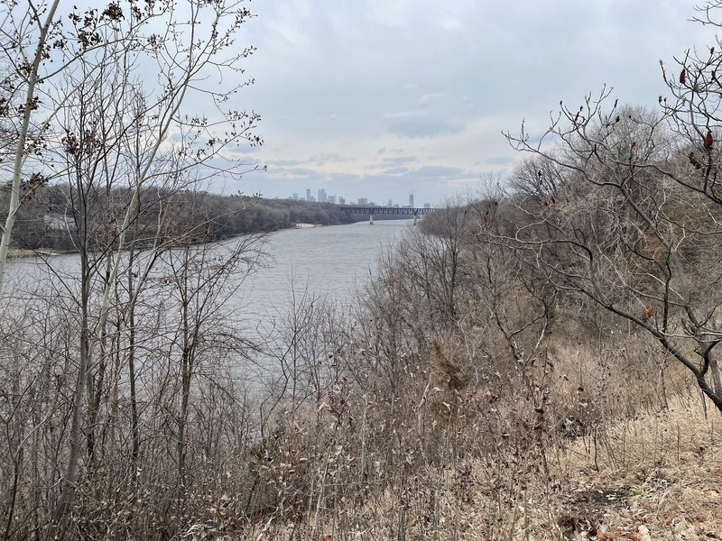 From the sidewalk, the Mississippi with the Minneapolis skyline.