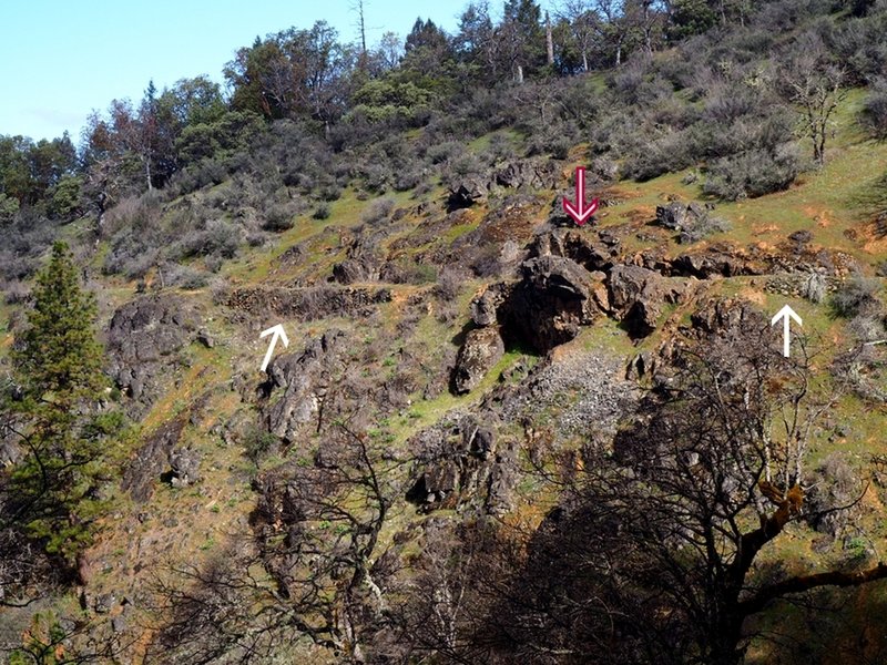 Looking across the gulch to the Chinese Wall (white arrows) and the channel (red/white) arrow cut through the outcrop.