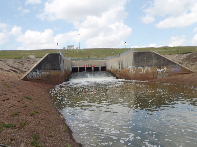 The spillway coming through the dike into Langham Creek channel, from the south side looking north.