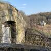 Root cellar with farm buildings in distance.