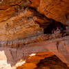 Hikers looking out from Soldier Pass Cave.