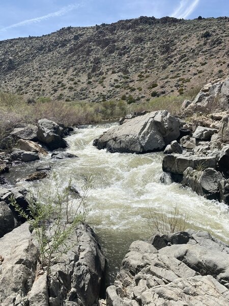 Water flowing super fast down a small man made waterfall,