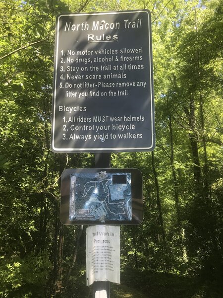 Trailhead sign behind the community center playground.