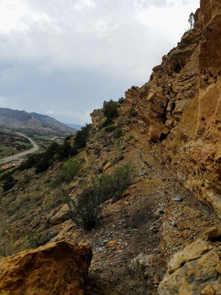 Trail runs along the rocky steep rugged terrain.