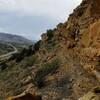 Trail runs along the rocky steep rugged terrain.