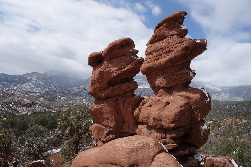 Siamese Twins rock formation at the Garden of the Gods with the Rockies in the background.