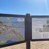 Three panels of information signage just past the main parking lot.