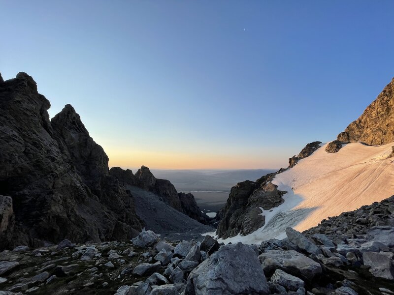 View to the east of the saddle, looking into Garnet Canyon and at Bradley Lake at the bottom. At sunrise.