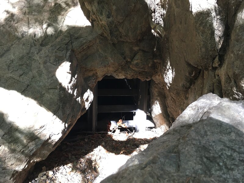 The gated Dawn Mine entrance (hiding behind a boulder).