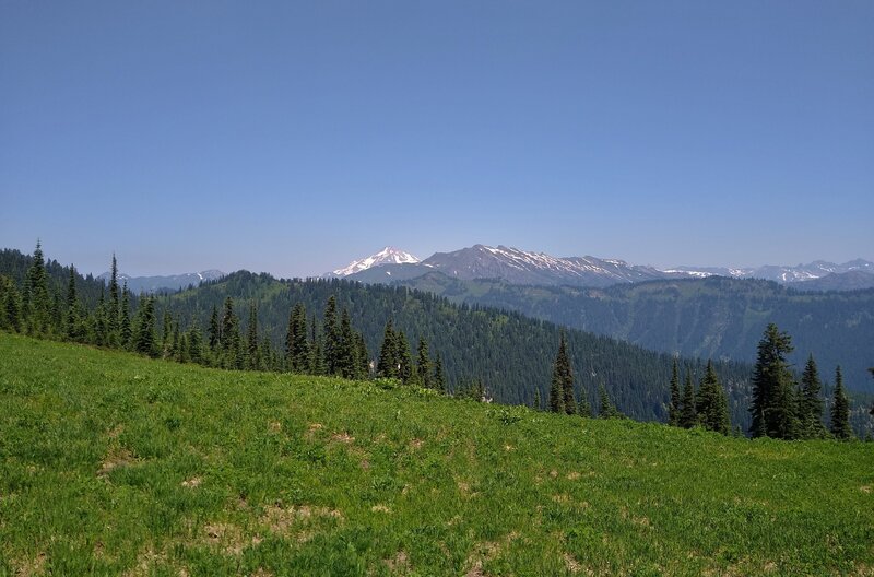 The meadows at the top of Cady Ridge, other nearby ridges, and Glacier Peak, 10.541 ft. (center left), in the distance to the north.