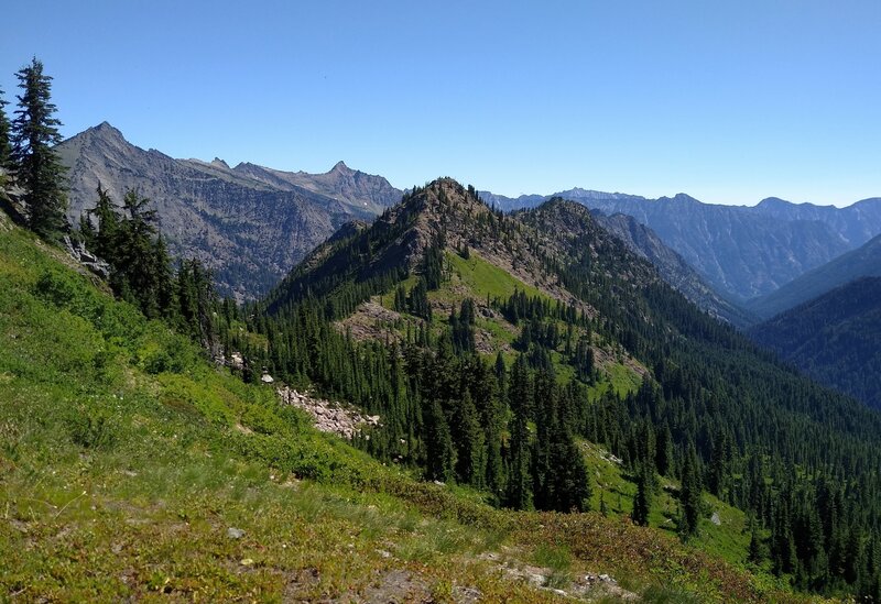 Mountains to the northeast emerge high on Wenatchee Ridge Trail. Whittier Peak, 7,281 ft., is the pointy peak on the far left.