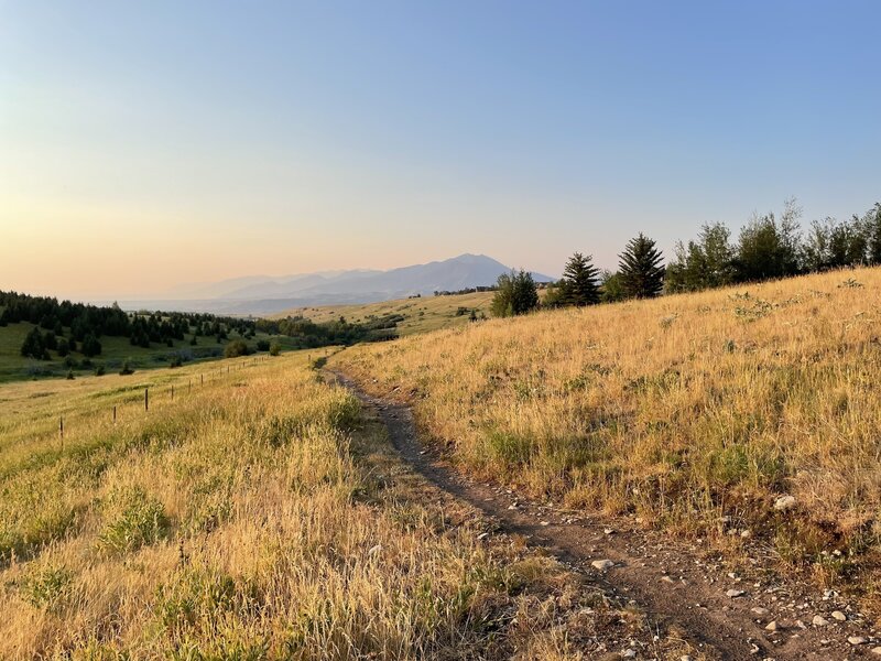 View of the Bridger Range with smoke and evening light.