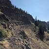 The trail carved into side of the hill, often narrow, narrow slippery tread on trail.