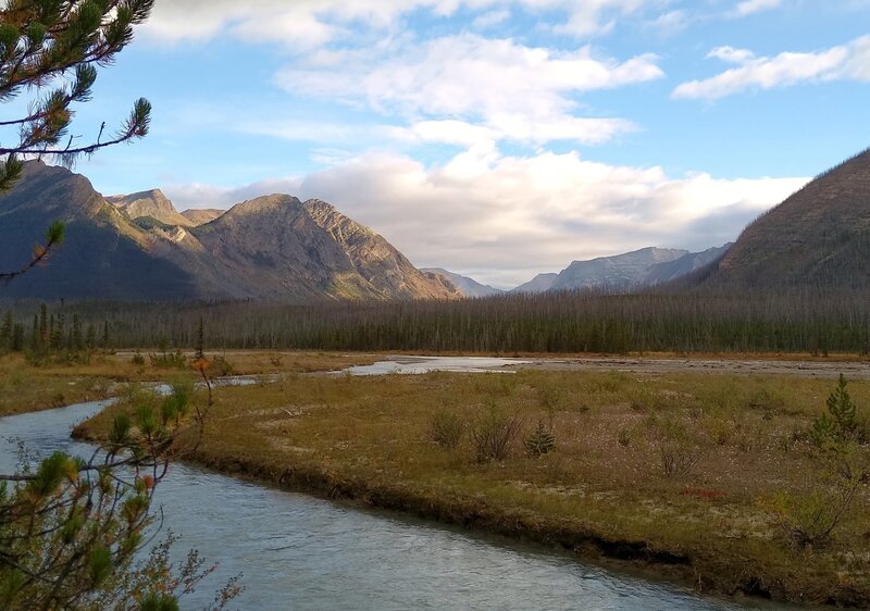 From the banks of Resplendent Creek at Resplendent Creek trail camp, to the north-northeast is the Moose River valley. Moose River bends to the left behind Trio Mountain (center left). The far distant valley beyond Trio Mountain is Upright Creek valley.