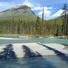 The gorgeous, turquoise Moose River meanders lazily along a flat section of its valley.