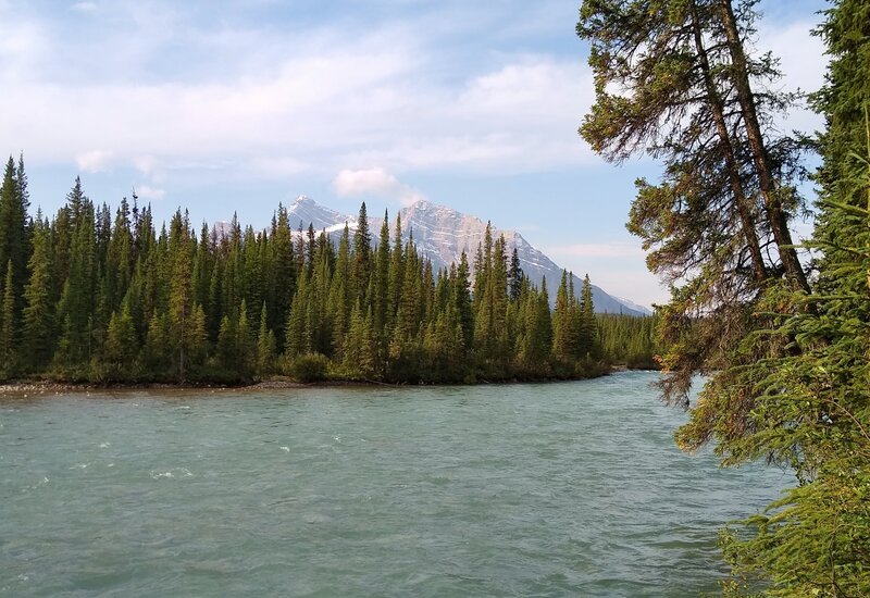 The double peaked Rajah, 9,901 ft. Seen from Wellbourne trail camp when looking south-southwest on the banks of the Snake Indian River.