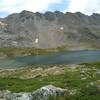 Climbing towards Europe Pass, the fourth lake on the way to the pass, Lake 10813, is set in the alpine meadows below.
