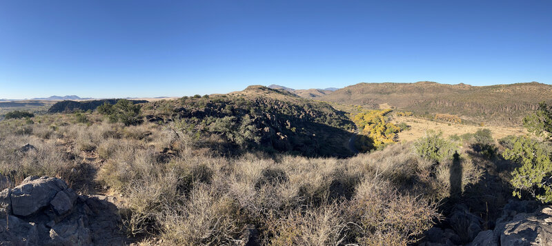 View of the Limpia Creek and surrounding hillsides from a scenic viewpoint on the Tall Grass Loop Trail.