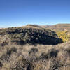 View of the Limpia Creek and surrounding hillsides from a scenic viewpoint on the Tall Grass Loop Trail.