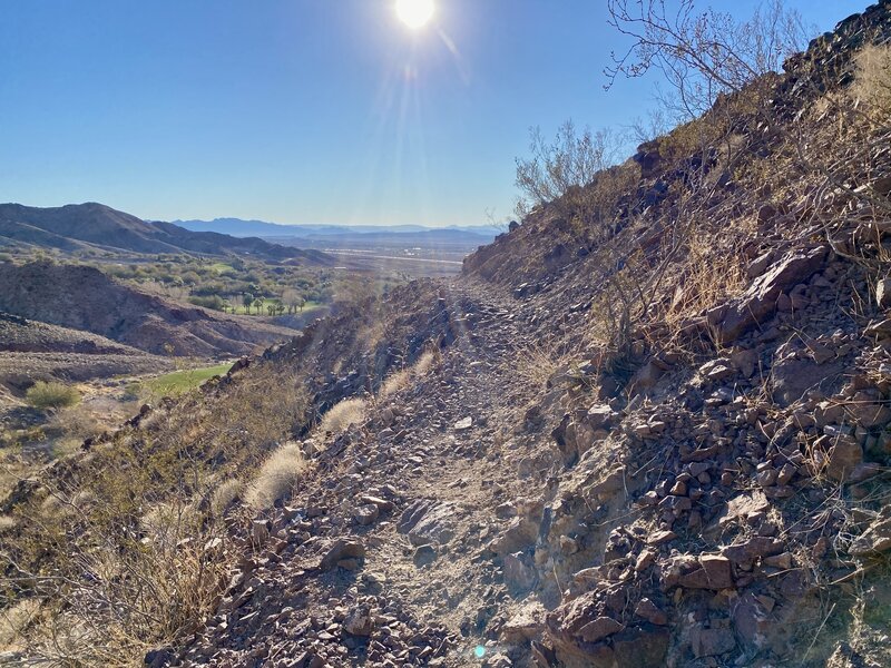 Skinny singletrack descent along the mountainside.