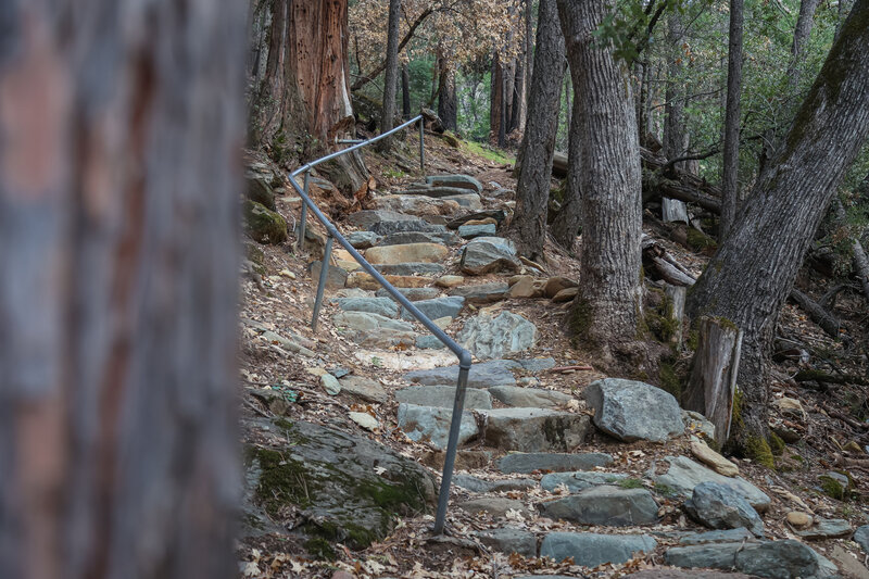 Stone steps descend the last bit of trail before reaching the creek's edge.