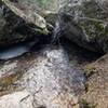 Stream flowing over rocks on trail