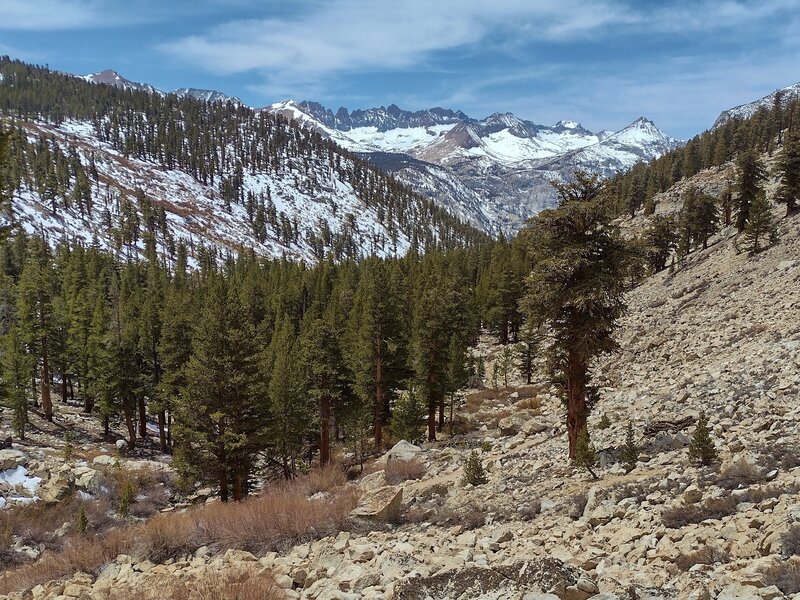 Wallace Creek cascades down this valley to empty into the Kern River.  Far in the distance left to right, are The Kaweahs and Lawson Peak, with Picket Guard Peak the rightmost peak, slightly closer. Seen looking west-southwest down Wallace Creek valley.