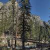 The Lower Kern Bridge from its west end. Kern River below, east side Kern Canyon cliffs rising 2,000 feet. Tower Rock, 8.469 ft. (center left) towers over the bridge.