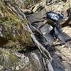 A hiker climbs a steep section of Devil's Path.