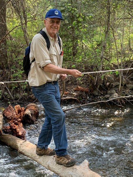 Creek crossing with the aid of a rope and log