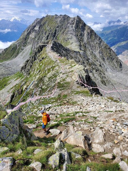 Strange saddle just below Eiggishorn lift with rolled up fencing for ski season.