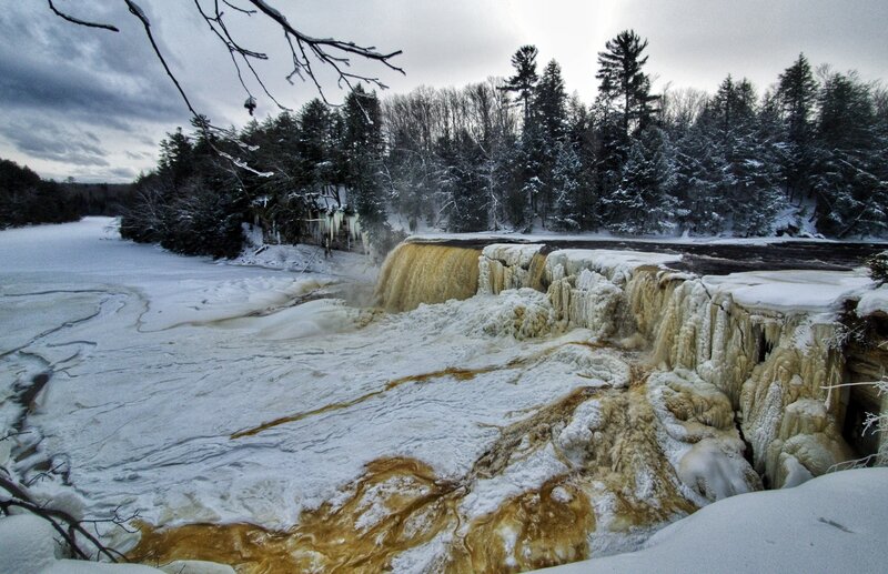 Mostly-frozen Tahquamenon Falls in winter from the primary viewing platform.