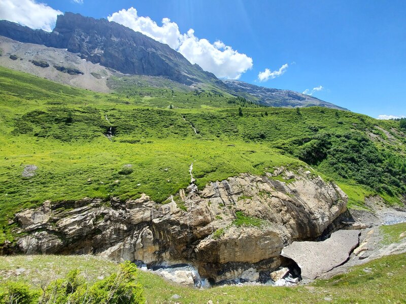 Huge chunks of debris-covered snow still in the creek bed by July.