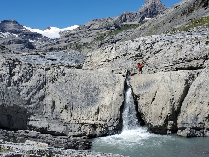 Waterfall cutting through a stone wall.