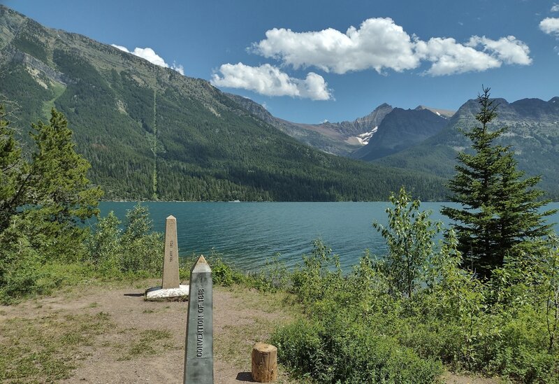 Canada/USA border - monuments and cutline showing to the east on the far side of Upper Waterton Lake.