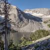 Looking down on Window Mountain Lake from the switchbacks on its north slope.  Behind the trees on the left is Mt. Ward. The rock wall on the right is part of the Great Divide.