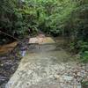 Cement river crossing.  Be careful as the moss and moving water can make it slippery.