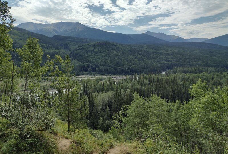 The Smoky River is seen below with a backdrop of the forested mountains on the way to Eaton Falls.