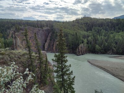 The Smoky River flowing towards the Sulphur Gates cliffs, left-center.