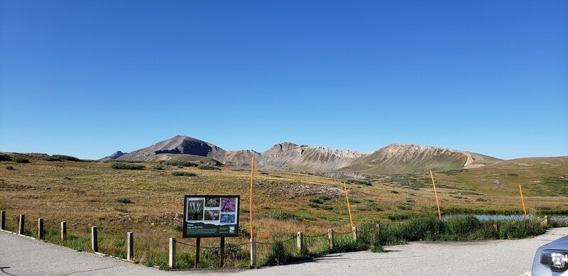 Taken from the Independence Pass parking area. Igloo Peak is in between the first two orange posts, and the trail can be traced along the ridge to the right. The beginning of the paved Overlook path can be seen bottom left.