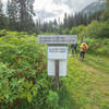 Trailhead sign and train times on the reverse side of the sign.