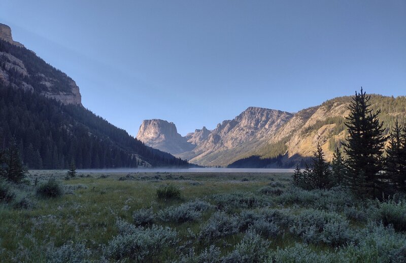 Early morning on the trail at the north end of Upper Green River Lake. Squaretop Mountain is in the distance left of center.