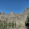 Snyder Lake surrounded by impressive cliffs.  Little Matterhorn, 7,886 ft., (center) rises from the cliffs.