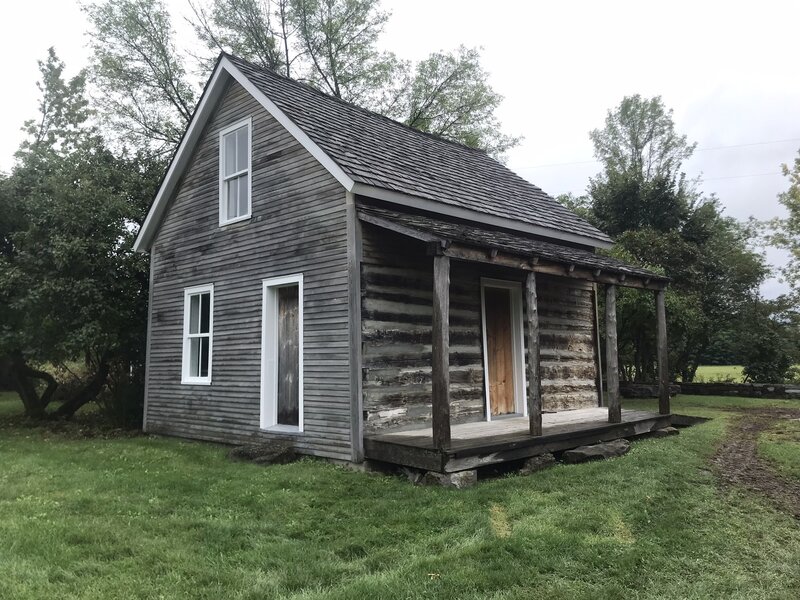 A log cabin near the historical society building.