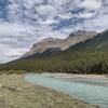 The Alexandra River at its river flats near where Castleguard River empties into it. Looking downstream (east-northeast) the two peaks in the center are thought to be Mt. Amery (center left) and Willerval Mountain (center right).